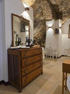 a dresser with a mirror on top of it at La Maison in Vallata