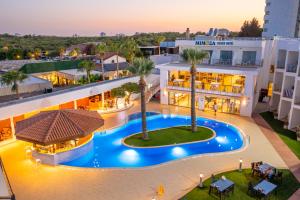 an aerial view of a hotel with a swimming pool at Mimoza Beach Hotel in Yenibosazici