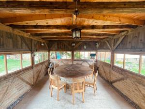 a dining room with a wooden table and chairs at Ferma de Biodiversitate COBOR in Cobor +42 photos