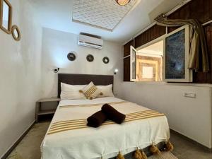 a bedroom with a large bed in a room at Riad Eglantine in Touggana