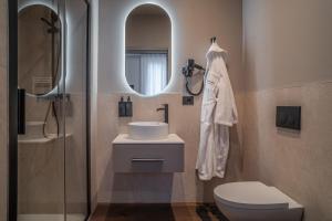 a bathroom with a sink and a toilet and a mirror at Porpora Suite Hotel in Milan