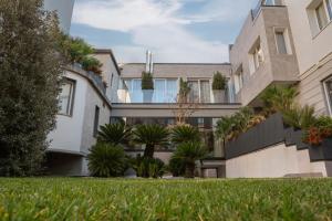 an exterior view of a building with a yard at Porpora Suite Hotel in Milan