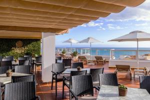 a restaurant with a view of the ocean at Aluasun Lago Rojo - Adults recommended in Torremolinos