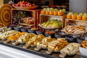 a buffet filled with different types of cheese and fruit at Aluasun Lago Rojo - Adults recommended in Torremolinos