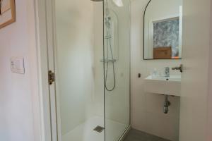 a bathroom with a shower and a sink at Hostal La Muralla in Seville