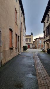 an empty street next to an old building at Clos Germanois entre Clermont, Lyon ,St Etienne A89 sortie 32 in Saint-Germain-Laval