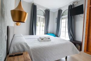 a bedroom with a bed with two towels on it at Hostal La Muralla in Seville