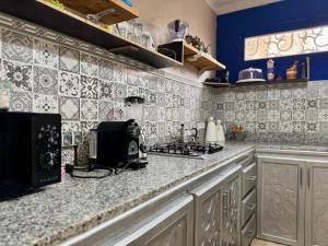 a kitchen with a counter top with a microwave at Riad Eglantine in Touggana