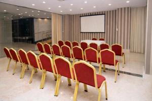 a conference room with a table and red chairs at Alder Resort Hotel -Ultra All Inclusive in Kemer +61 photos