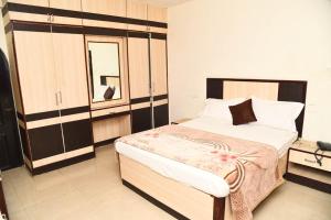 a bedroom with a large bed in a room at Hotel Mars in Chennai
