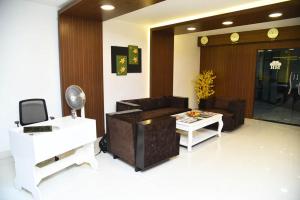 a living room with a couch and a table at Hotel Mars in Chennai