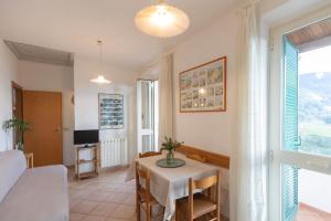 a living room with a table and a bedroom at Appartamenti Belvedere by ElbaSummer in Lacona