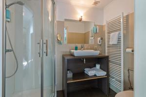 a bathroom with a sink and a shower at Hotel Brasserie de Klok in Zutendaal +72 photos