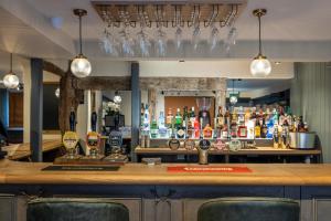 a bar with a lot of bottles of alcohol at The Horns Pub - Crazies Hill in Hurley