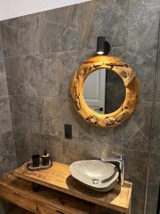 a bathroom with a sink and a mirror at Loft by GIORGI - Centre de Bastogne in Bastogne +9 photos
