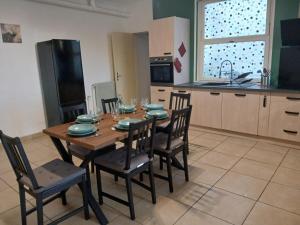a kitchen with a wooden table and chairs in a kitchen at Centre de vacances Chausse in Chamborigaud