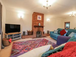 a living room with a couch and a fireplace at The Pantiles in Norwich