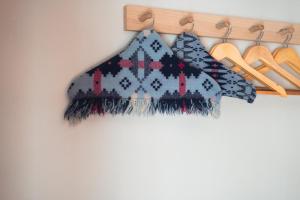 a scarf and sandals are hanging on a rack at Ty'n Llan- tafarn gymunedol- community pub in Llandwrog +45 photos