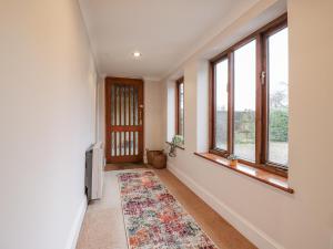 an empty hallway with windows and a rug at The Pantiles in Norwich +7 photos