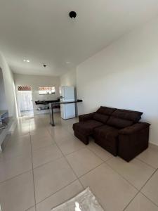 a living room with a brown couch and a kitchen at Casa Prado in Prado +10 photos
