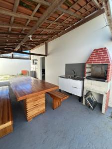 a kitchen with a wooden table and a stove at Casa Prado in Prado