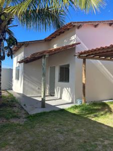 a house with a palm tree in front of it at Casa Prado in Prado