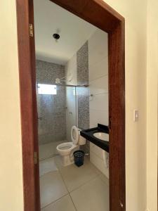 a bathroom with a toilet and a sink at Casa Prado in Prado