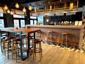 a bar with a wooden table and bar stools at Sørmarka Konferansehotell in Siggerud +42 photos