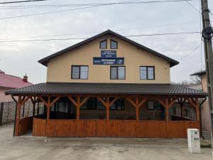 a building with a sign on top of it at Casa Drăghici in Nucet