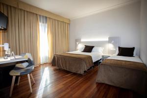 a hotel room with two beds and a desk at Tudanca Miranda in Miranda de Ebro +73 photos