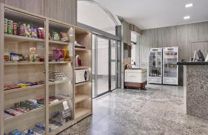 a grocery store with two refrigerators in a room at Hotel Nacional Inn Limeira in Limeira
