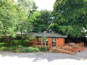 a small house with a porch and a deck at The Hermitage in Penrith +14 photos