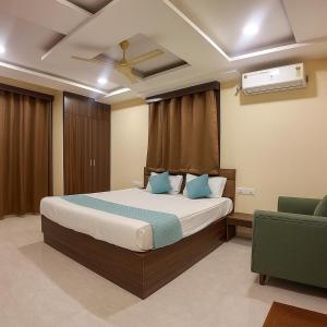 a bedroom with a bed and a ceiling fan at Olive Hotel in Hyderabad