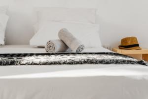 a bed with two towels and a hat on it at Naxos Aethereal View in Kastraki