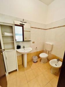 a bathroom with a sink and a toilet at Smart Rooms in Molinella