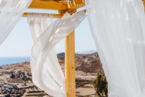 a wooden altar with white curtains in the desert at Naxos Aethereal View in Kastraki