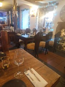 a dining room with a wooden table and chairs at The Royal Oak Hotel in Chapel en le Frith
