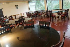a dining room with tables and chairs in a room at Nature Quite in Vattavada