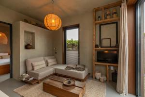 a living room with a couch and a table at PUUR aan de Zeeuwse kust in Wemeldinge