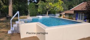 a swimming pool in a backyard with at Chambre d'hôte La Brindille in Mariac