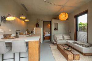 a kitchen and living room with a couch and a table at PUUR aan de Zeeuwse kust in Wemeldinge