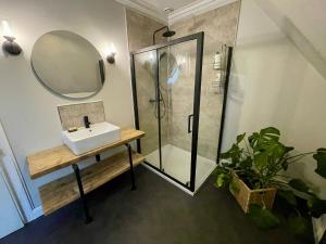 a bathroom with a shower and a sink and a mirror at Room 3, Wedale House in Stow