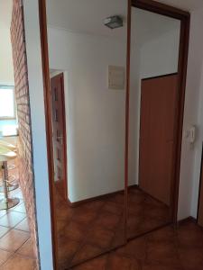 a large mirror in a room with a door at Rooftop Apartment in Šamorín +2 photos