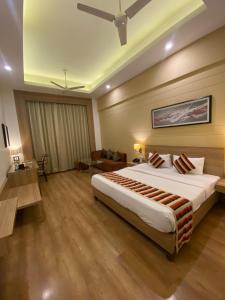 a bedroom with a large bed in a room at Hotel KC Cross Road Panchkula in Panchkula +6 photos