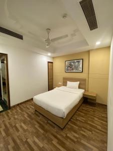 a bedroom with a white bed in a room at Hotel KC Cross Road Panchkula in Panchkula