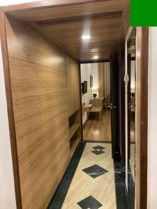 a hallway with a wooden door in a room at Hotel KC Cross Road Panchkula in Panchkula