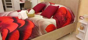 a bedroom with a bed with red pillows at B&B Il Catepano in Troia