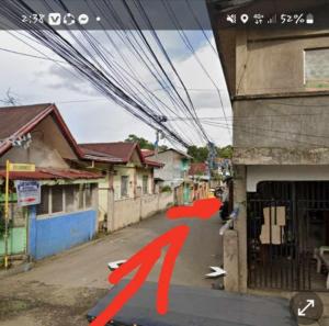 a street with a red person on the side of a building at Jessa's Transient Studio with Balcony in Masbate