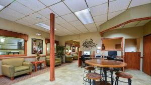 a lobby of a hospital with a table and chairs at Studio 6 - Minot, ND in Minot