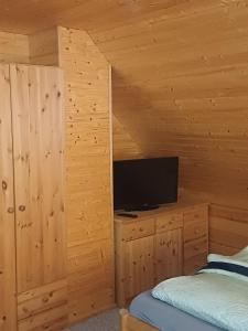 a bedroom with a bed and a flat screen tv at Holiday Home Fleesensee in Göhren-Lebbin